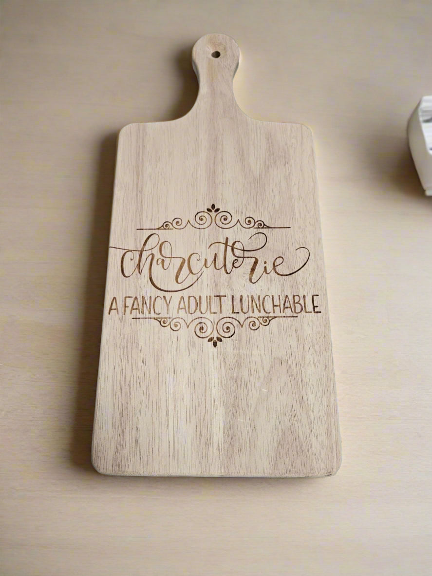 Wooden cutting board with decorative text on a patterned fabric background
