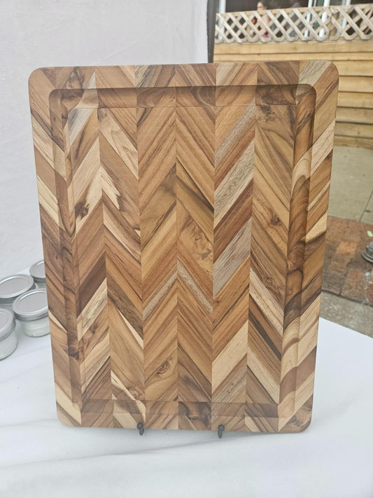 Wooden cutting board with a herringbone pattern on a white surface