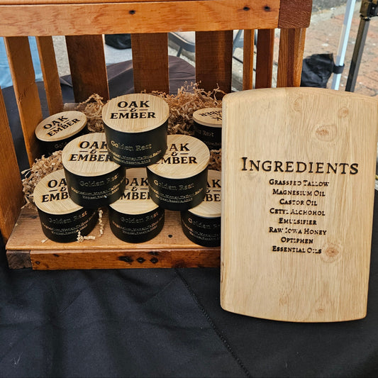 Wooden display with jars labeled 'Oak & Elder' and 'Magnesium Tallow Balm' on a chair outdoors.