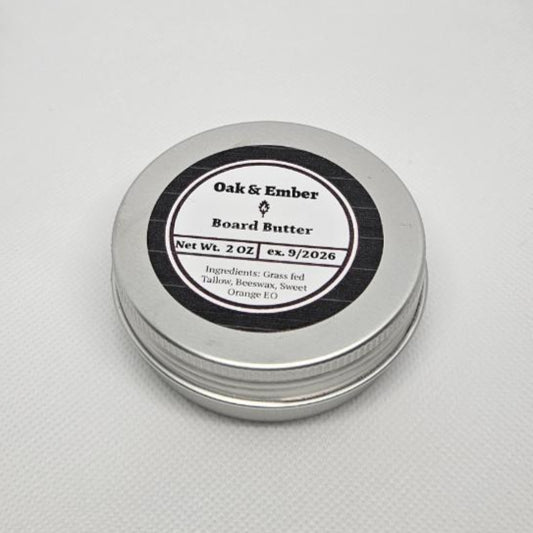 Small tin of body butter on a textured white surface