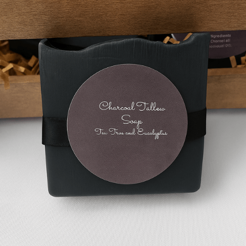 Black soap bar with a round label on a white surface