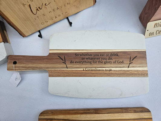 Wooden cutting board with engraved text on a white surface