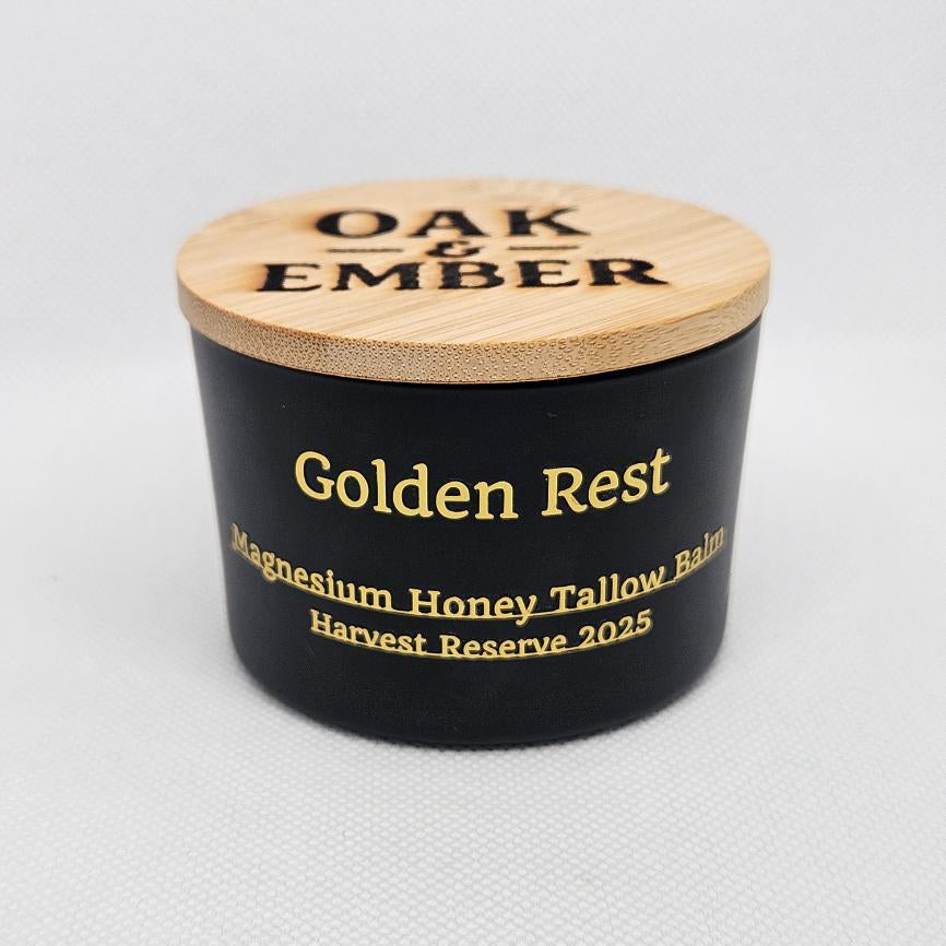 Black container with wooden lid labeled 'Oak & Ember Golden Rest' on a light gray background