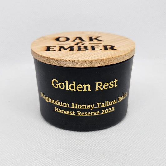 Black container with wooden lid labeled 'Oak & Ember Golden Rest' on a light gray background