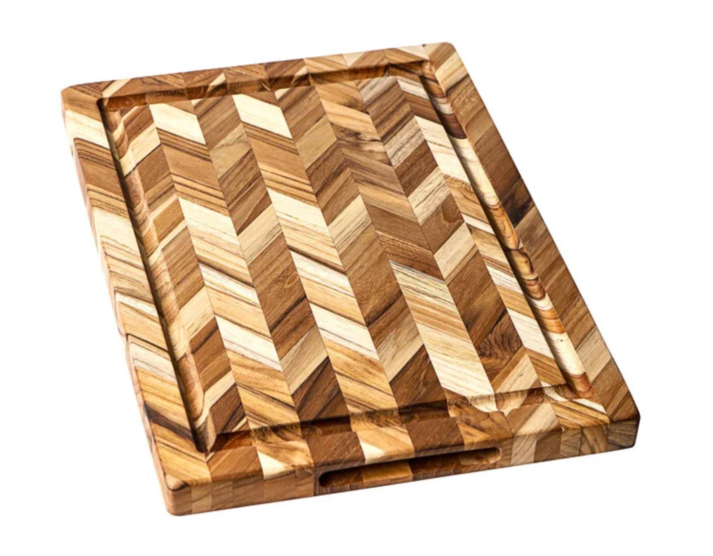 Wooden cutting board with a chevron pattern on a white background