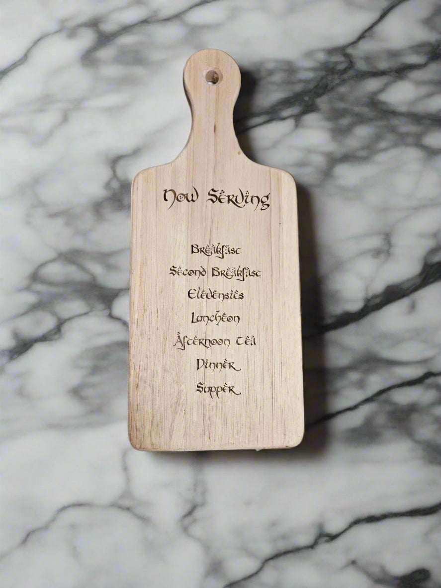 Wooden paddle with text on a patterned fabric background