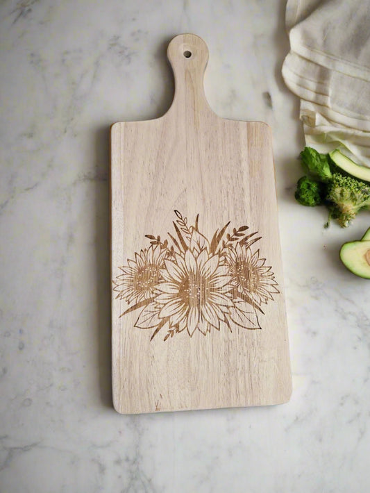 Wooden cutting board with floral design on a patterned fabric background