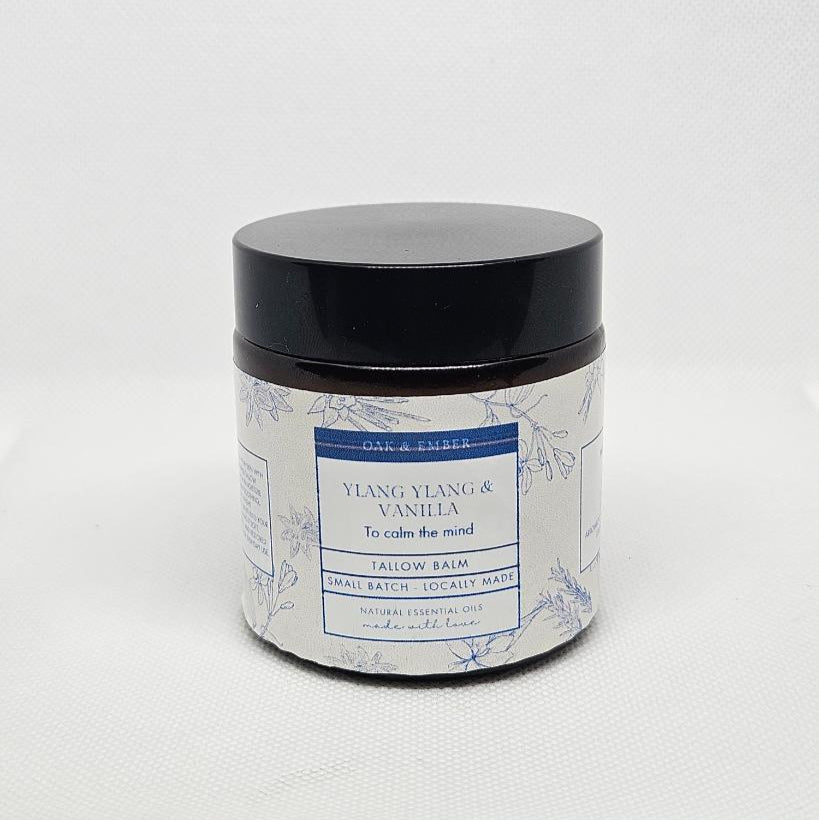 Candle jar with floral label on a white background