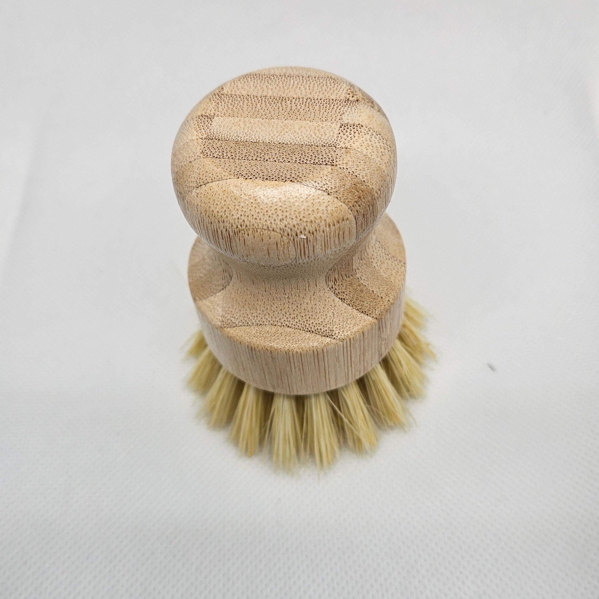 Wooden brush with bristle head on a light gray background