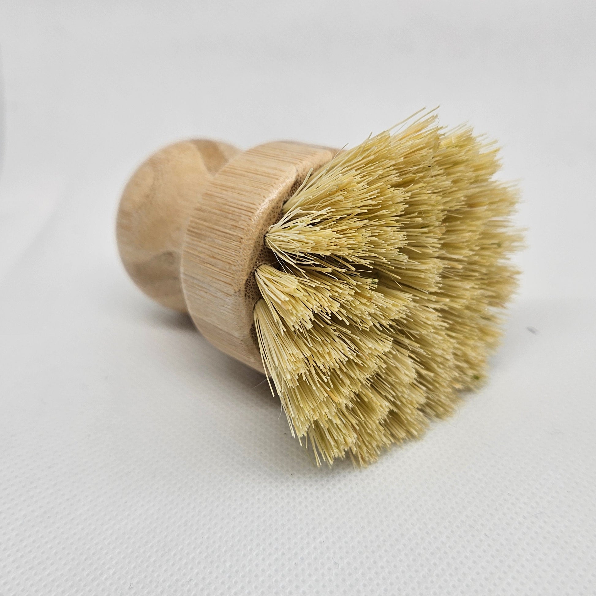 Bristle brush with wooden handle on a white background