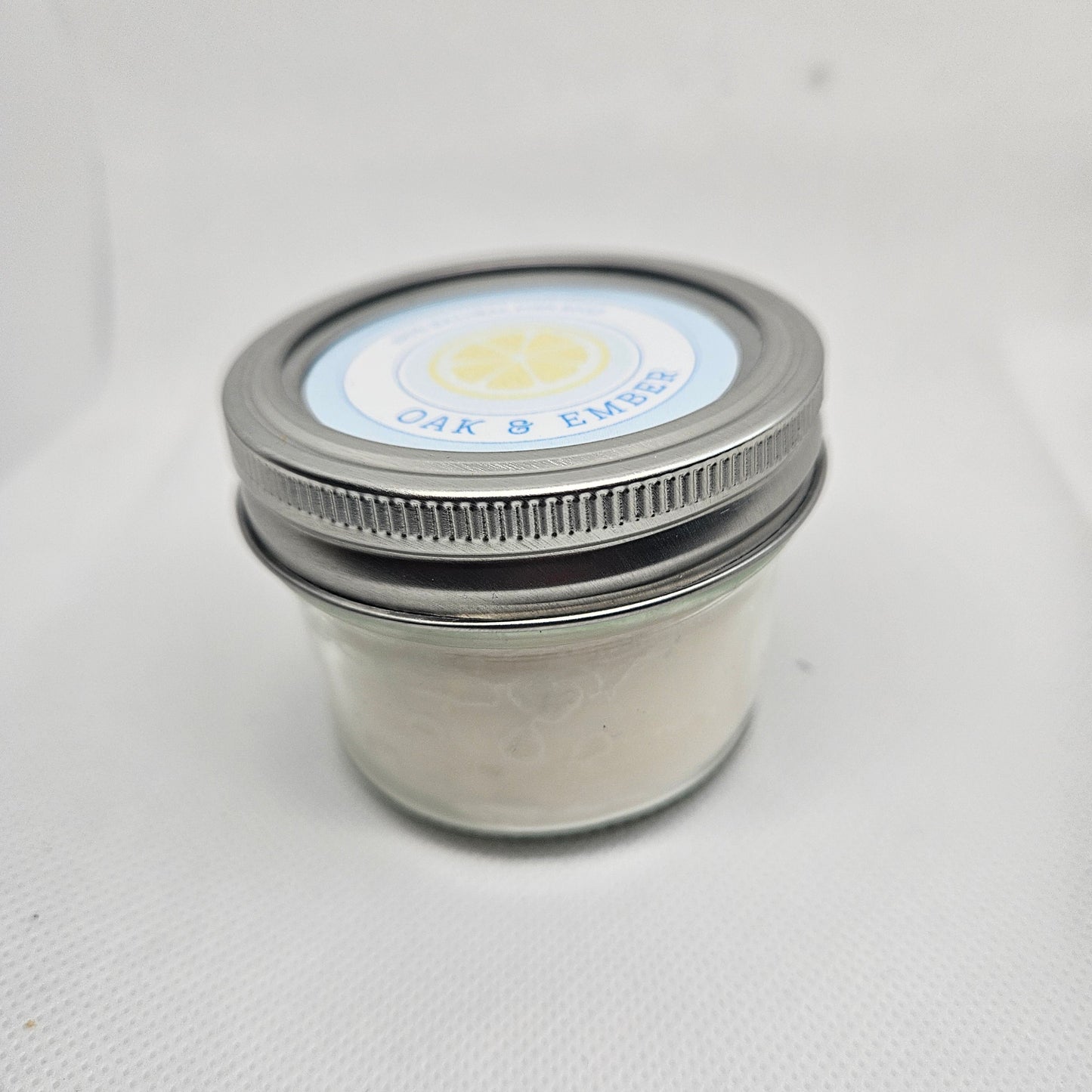 Close-up of a metal jar with a lid on a white background
