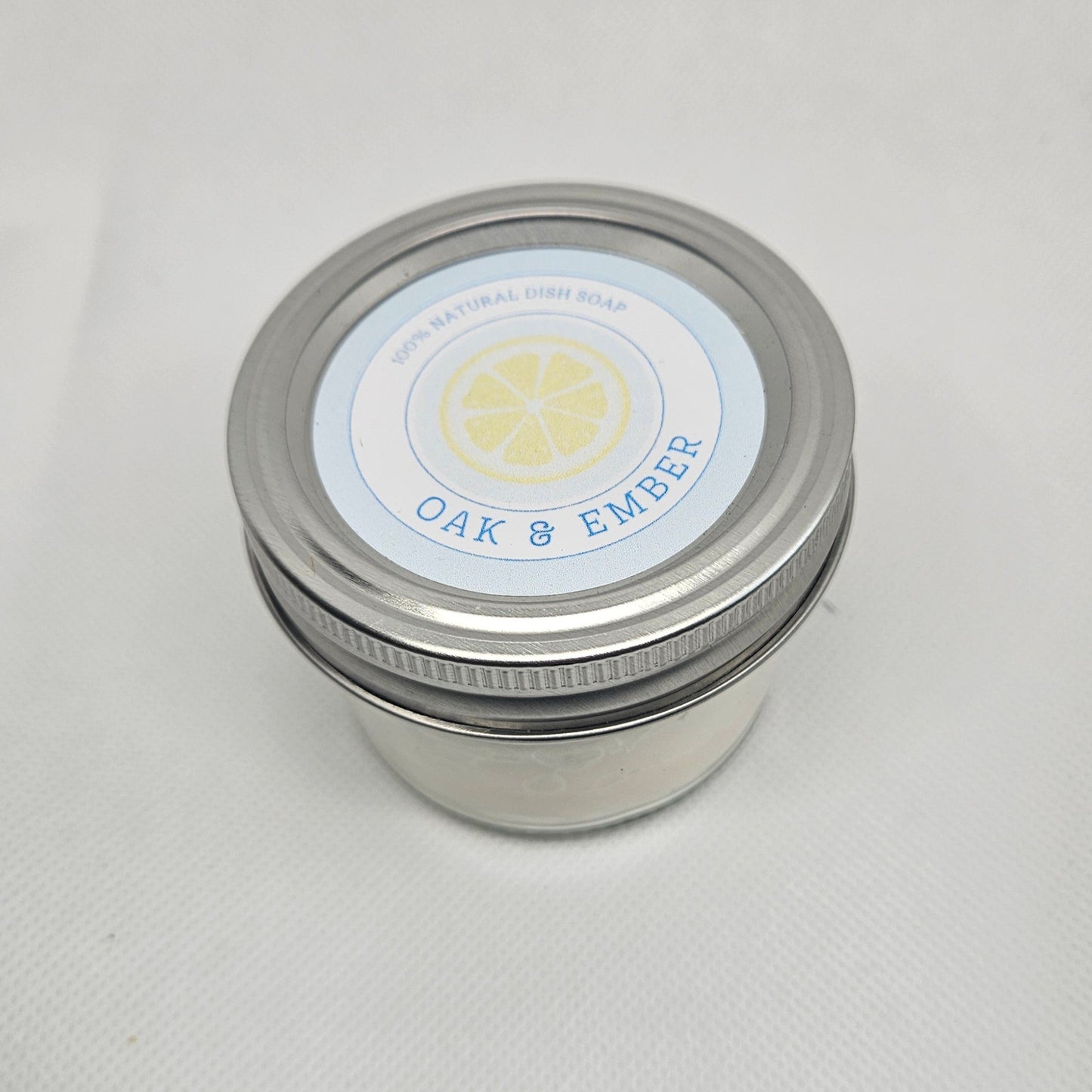 Silver jar with a label on a white surface