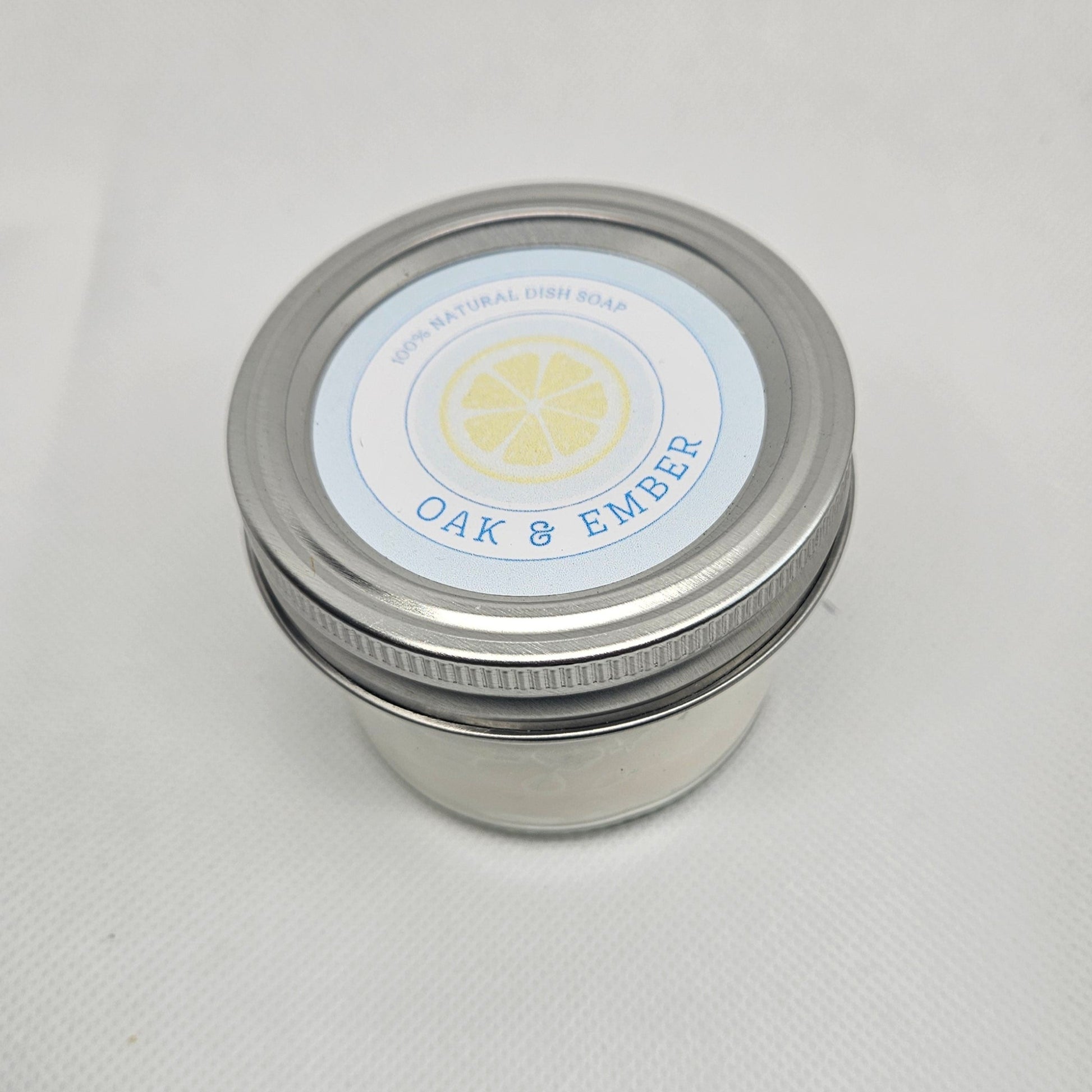 Silver jar with a label on a white surface