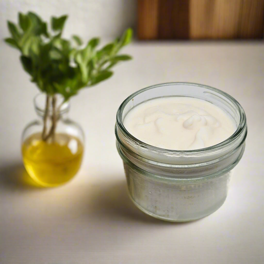 Wooden dish brush with a glass container of white powder on a light gray background
