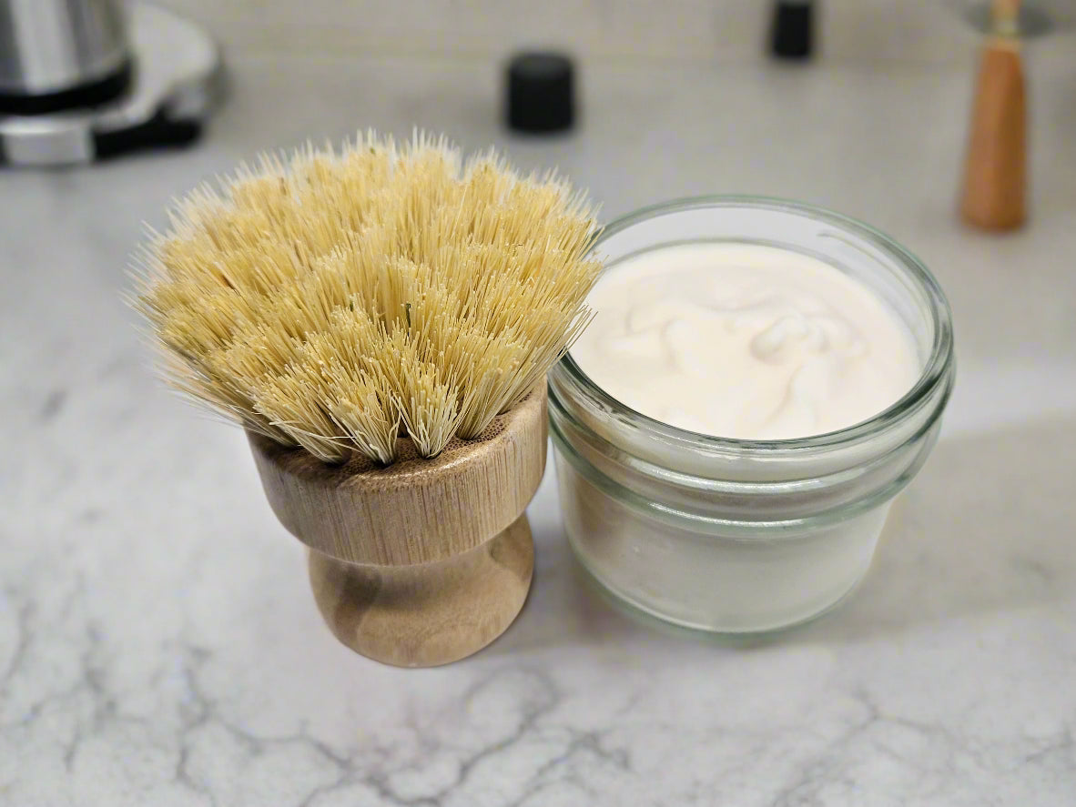 Shaving brush and jar of cream on a white background